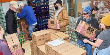0625 Newsflash Volunteers unload many boxes of food in the GCFP storeroom.