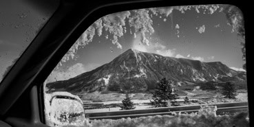 A frozen Mt. Crested Butte as seen through a car window.