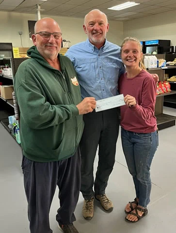 GCFP Staff accepts a check from a donor in the Gunnison Country Food Pantry.