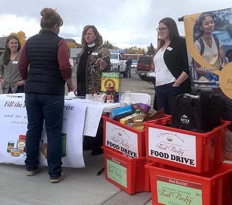 Volunteers and donors talk at a GCFP Red Bucket Food Drive.