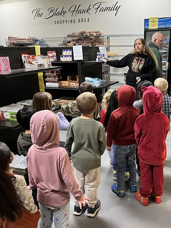 A group of young children taking a tour of the Pantry.