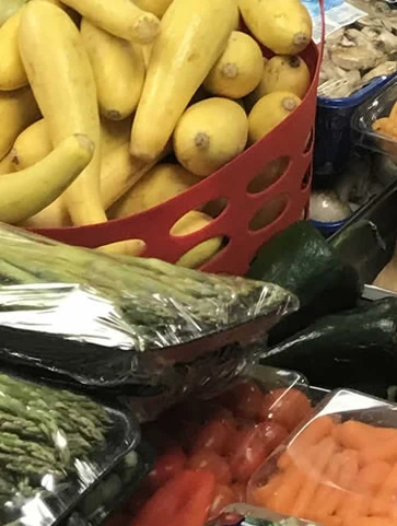 A large selection of fresh vegetables from the pantry: yellow squash, asparagus, carrots, and zucchini.
