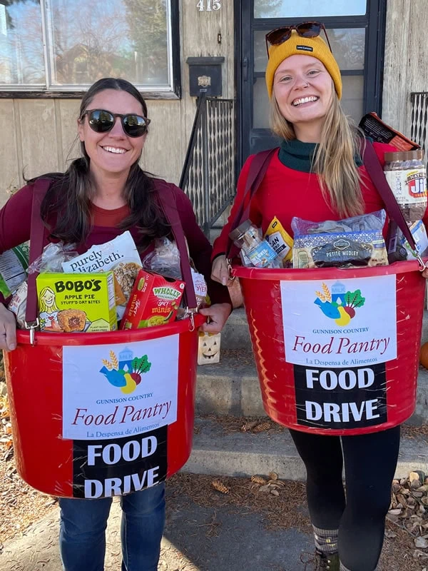 Jodi and Sam of the Gunnison Country Food Pantry Dress up as Red Buckets for a food drive.